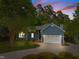 Charming blue house with lush landscaping, long driveway, and an attached two-car garage at 2123 Fountain Ridge Rd, Chapel Hill, NC 27517