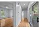 Inviting hallway with hardwood floors leads to a bedroom and outdoor access, creating a seamless transition at 2123 Fountain Ridge Rd, Chapel Hill, NC 27517