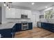 Stylish kitchen featuring white and blue cabinetry, stainless steel appliances, and modern finishes at 2123 Fountain Ridge Rd, Chapel Hill, NC 27517