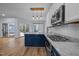 Modern kitchen with stainless steel appliances, center island, and wood-look flooring offers a stylish cooking space at 2123 Fountain Ridge Rd, Chapel Hill, NC 27517