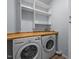 Neat laundry area featuring a front-load washer and dryer and countertop at 2123 Fountain Ridge Rd, Chapel Hill, NC 27517