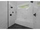 Luxurious walk-in shower featuring multiple shower heads, a built-in bench, and modern tile design at 2123 Fountain Ridge Rd, Chapel Hill, NC 27517