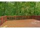 View of a stained deck overlooking a lush, green backyard with privacy from the surrounding trees at 225 Bay Dr, Cary, NC 27511