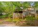 View of backyard with lush trees, fenced yard, a shed, and wooden stairs leading up to the house at 225 Bay Dr, Cary, NC 27511
