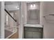 Bathroom with granite countertop vanity, decorative mirror, and natural-tone painted walls at 225 Bay Dr, Cary, NC 27511