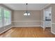 Traditional dining room with hardwood floors, chandelier lighting, and natural light from a window at 225 Bay Dr, Cary, NC 27511