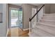 Foyer with hardwood flooring, a carpeted staircase and a blue door opening to the exterior at 225 Bay Dr, Cary, NC 27511