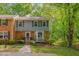 Charming two-story townhouse with a well-maintained yard, brick accents, and beautiful blue shutters at 225 Bay Dr, Cary, NC 27511