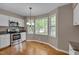 Eat-in kitchen featuring stainless steel appliances, granite countertops, and a bay window nook at 225 Bay Dr, Cary, NC 27511