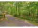 A paved path lined with wooden fences winds through the lush green landscape at 225 Bay Dr, Cary, NC 27511