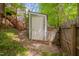 A storage shed sits near the fenced yard on a property with steps and a natural green landscape at 225 Bay Dr, Cary, NC 27511
