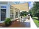 Cozy back deck with retractable awning, perfect for outdoor relaxation, featuring a table and chairs at 2318 Carriage Oaks Dr, Raleigh, NC 27614