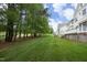Lush backyard with a well-manicured lawn and mature trees, offering a serene outdoor space at 2318 Carriage Oaks Dr, Raleigh, NC 27614