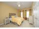 Cozy bedroom with warm colors, plush carpeting, and ample natural light at 2318 Carriage Oaks Dr, Raleigh, NC 27614