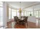 Dining room with a chandelier, hardwood floors, large windows, and an elegant design at 2318 Carriage Oaks Dr, Raleigh, NC 27614