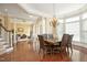 Open-concept dining room featuring hardwood floors, a large table, and views into the other living spaces at 2318 Carriage Oaks Dr, Raleigh, NC 27614