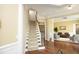 Spacious foyer with hardwood floors, a staircase, and views into the living area at 2318 Carriage Oaks Dr, Raleigh, NC 27614