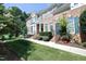 Inviting brick townhome with a landscaped front yard, a balcony, and a peaceful setting at 2318 Carriage Oaks Dr, Raleigh, NC 27614