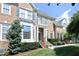Charming brick townhome with well-maintained landscaping, a balcony, and a welcoming front entrance at 2318 Carriage Oaks Dr, Raleigh, NC 27614