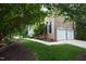 Beautiful brick house with a well-maintained lawn and landscaping, showcasing a two-car garage at 2318 Carriage Oaks Dr, Raleigh, NC 27614