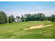 Beautiful golf course view with sand traps and manicured green grass in a picturesque community at 2318 Carriage Oaks Dr, Raleigh, NC 27614