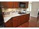Updated kitchen featuring granite countertops, stainless appliances, and a gas cooktop at 2318 Carriage Oaks Dr, Raleigh, NC 27614