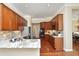 Gourmet kitchen with granite countertops, stainless steel appliances, and rich wood cabinetry at 2318 Carriage Oaks Dr, Raleigh, NC 27614