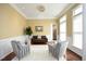 Comfortable living room with a brown sofa, two chairs, and plenty of natural light at 2318 Carriage Oaks Dr, Raleigh, NC 27614