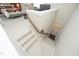 Wide staircase with carpet leading down to the next level, featuring white risers and wooden handrail at 2318 Carriage Oaks Dr, Raleigh, NC 27614