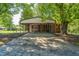 View of the carport on this brick home, which features covered parking with fenced perimeter and dual entrances at 2500 Courtland Dr, Sanford, NC 27330