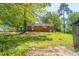 Charming single-story brick home featuring a well-maintained lawn and mature trees for ample shade and curb appeal at 2500 Courtland Dr, Sanford, NC 27330