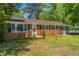 Charming brick home with a covered parking area and a well-manicured lawn at 2500 Courtland Dr, Sanford, NC 27330