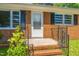 Inviting front porch of a brick home featuring classic details and a well-maintained entrance at 2500 Courtland Dr, Sanford, NC 27330