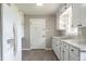 Bright kitchen features white cabinetry, a stainless steel refrigerator, and updated countertops at 2500 Courtland Dr, Sanford, NC 27330