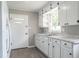 Close up of the kitchen featuring white cabinets and a door at 2500 Courtland Dr, Sanford, NC 27330