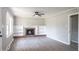 Spacious living room with a fireplace, built-in shelves, and a ceiling fan at 2500 Courtland Dr, Sanford, NC 27330