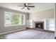 Sunlit living room showcasing a brick fireplace, white built-ins, and modern flooring at 2500 Courtland Dr, Sanford, NC 27330