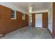 Enclosed patio with brick walls, white trim, and a door leading to the outside at 2500 Courtland Dr, Sanford, NC 27330