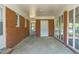 Enclosed patio with brick walls, white trim, and a door leading to the outside at 2500 Courtland Dr, Sanford, NC 27330