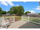 Backyard with wooden deck, red brick patio, wooden fence and mature trees at 281 Highland Forest Dr, Sanford, NC 27332