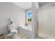 Bright bathroom featuring a tub, shower, and window with natural light at 281 Highland Forest Dr, Sanford, NC 27332