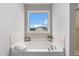 A gorgeous soaking tub in a pristine bathroom with lots of natural light at 281 Highland Forest Dr, Sanford, NC 27332