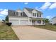 Charming two-story home featuring a welcoming front porch and attached two-car garage at 281 Highland Forest Dr, Sanford, NC 27332