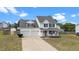 Charming two-story home featuring a welcoming front porch and attached two-car garage at 281 Highland Forest Dr, Sanford, NC 27332