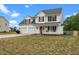 Charming two-story home featuring a welcoming front porch and attached two-car garage at 281 Highland Forest Dr, Sanford, NC 27332