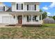 Charming front porch with white railings and colorful hanging baskets at 281 Highland Forest Dr, Sanford, NC 27332