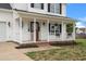 Inviting front porch with white columns and beautiful landscaping at 281 Highland Forest Dr, Sanford, NC 27332