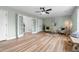 Bright living room with light wood floors, ceiling fan, seating area, and french doors at 281 Highland Forest Dr, Sanford, NC 27332