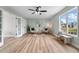 Bright living room with light wood floors, ceiling fan, and seating area at 281 Highland Forest Dr, Sanford, NC 27332
