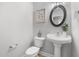 Clean powder room with pedestal sink, decor and neutral color palette at 281 Highland Forest Dr, Sanford, NC 27332